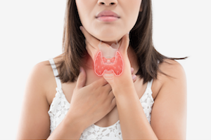 woman holding her neck with thyroid overlay