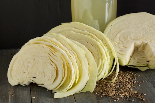 The ingredients for sauerkraut juice showing sliced cabbage, salt, and caraway seed